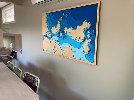 Custom map from Tides Out Maps hanging above a dining table — a meaningful wedding gift and home centrepiece.
