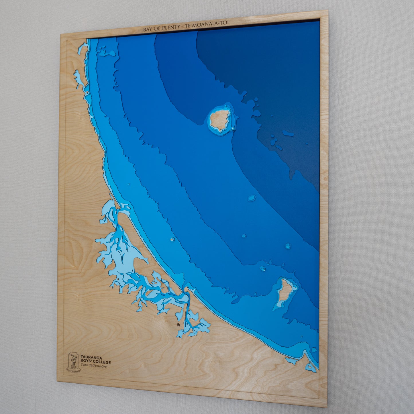 Bay of Plenty wooden depth map displayed in a room setting, illustrating its size and aesthetic appeal as wall art.