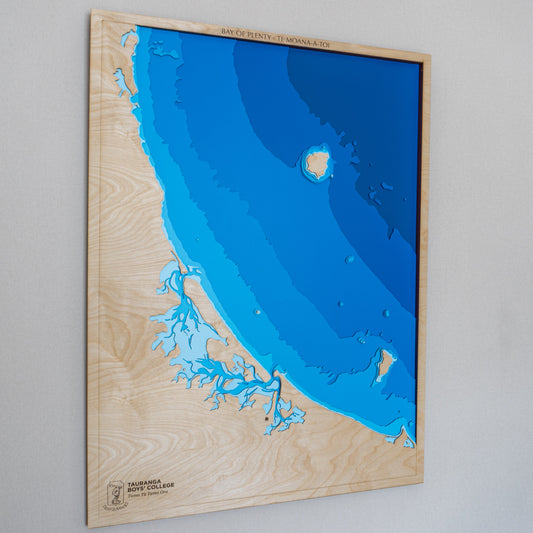 Handcrafted wooden depth map of the Bay of Plenty, New Zealand, showcasing laser-cut layers depicting the region's expansive coastline, islands, and surrounding ocean depths.