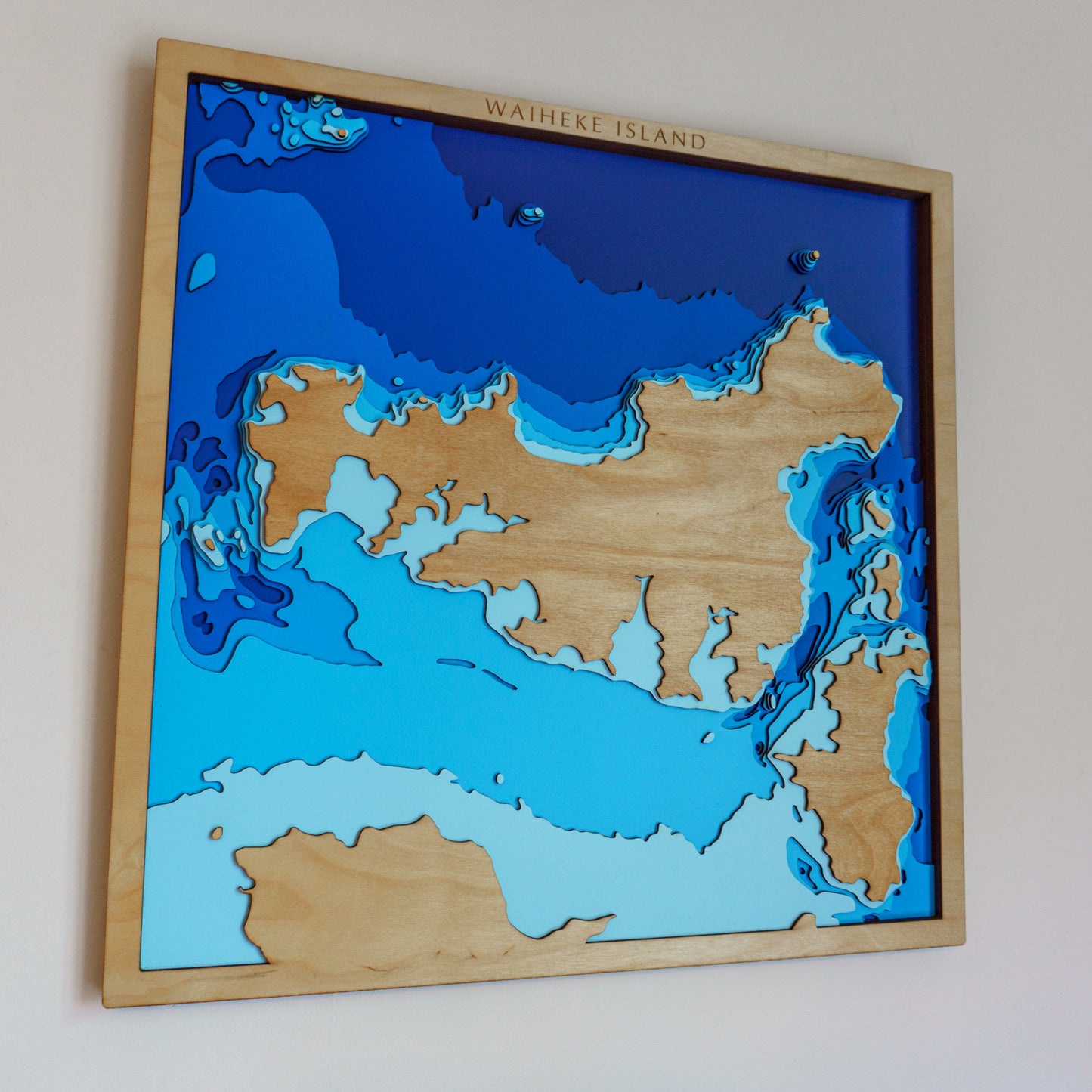 Close-up view of a custom medium wooden depth map showing detailed laser-cut bathymetric layers and personalized coastal features.