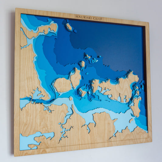 Handcrafted bathymetric map of the Hauraki Gulf showing ocean depth contours and key islands like Waiheke and Rangitoto
