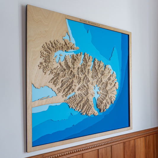 Extra-large handcrafted wooden depth map of Banks Peninsula, Canterbury, New Zealand, featuring laser-cut European Birch layers illustrating topographic elevations from 100m to 800m and sea depths from 0m to -100m, highlighting Lyttelton and Akaroa Harbours