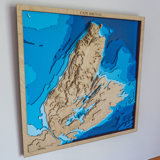 Handcrafted wooden depth map of Cape Breton Island, Nova Scotia, Canada, featuring laser-cut layers illustrating elevations from 400 meters above sea level to 200 meters below sea level.