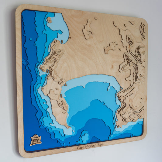 Handcrafted wooden depth map of Cape Town, South Africa, showcasing laser-cut layers depicting the city's coastline, Table Mountain, and surrounding ocean contours.