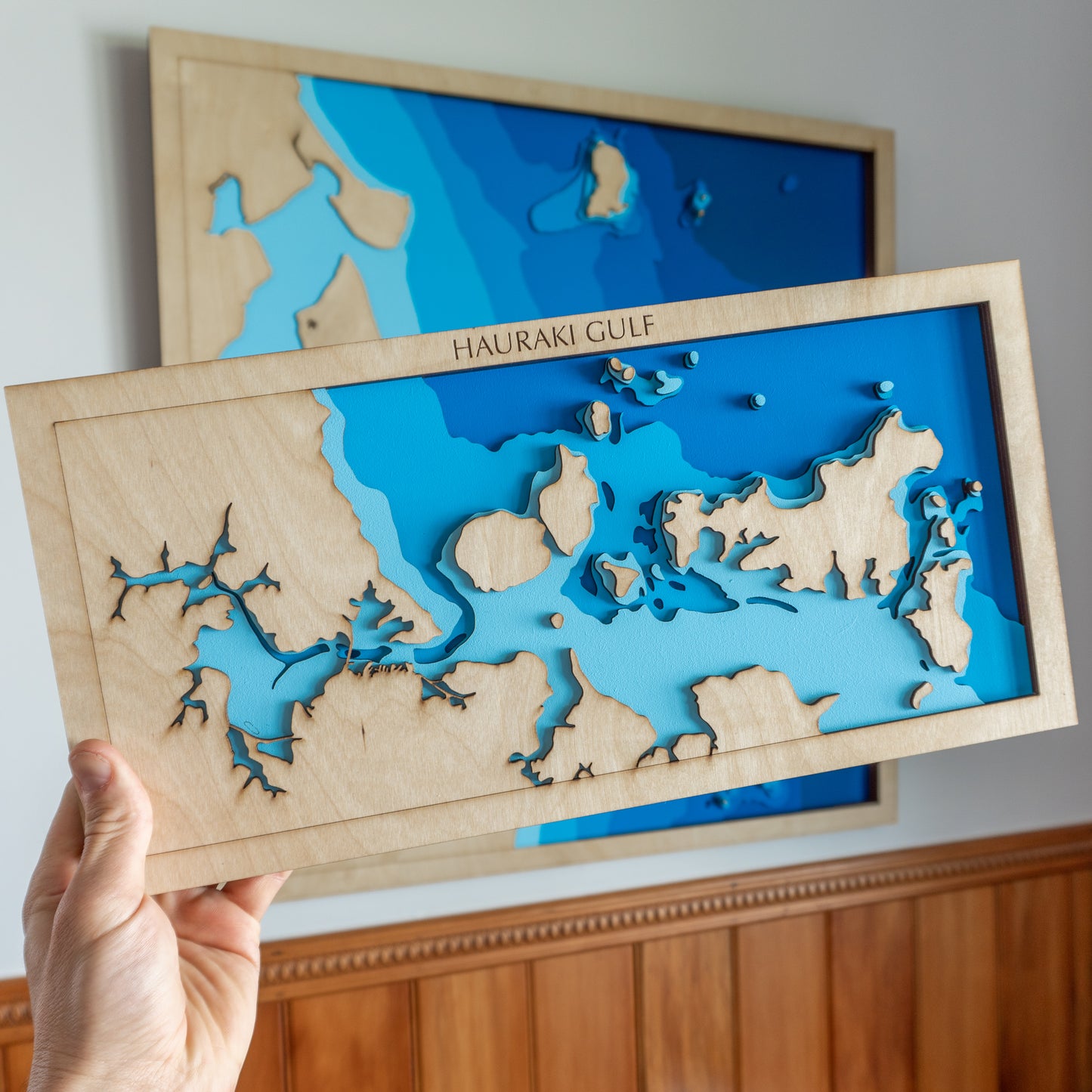 Close-up view of the Hauraki Gulf Mini map showing detailed laser-cut bathymetric layers and coastal features.