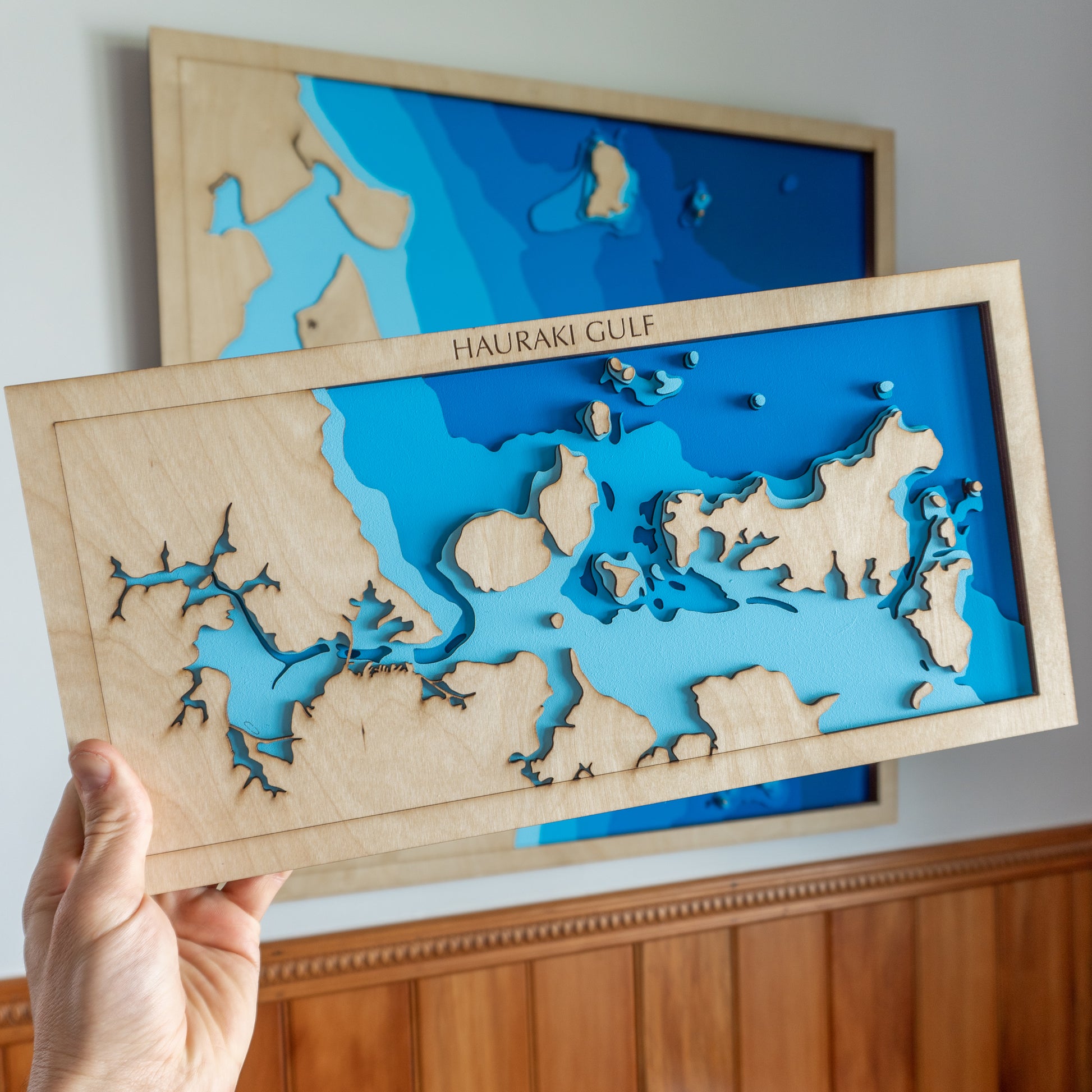 Close-up view of the Hauraki Gulf Mini map showing detailed laser-cut bathymetric layers and coastal features.