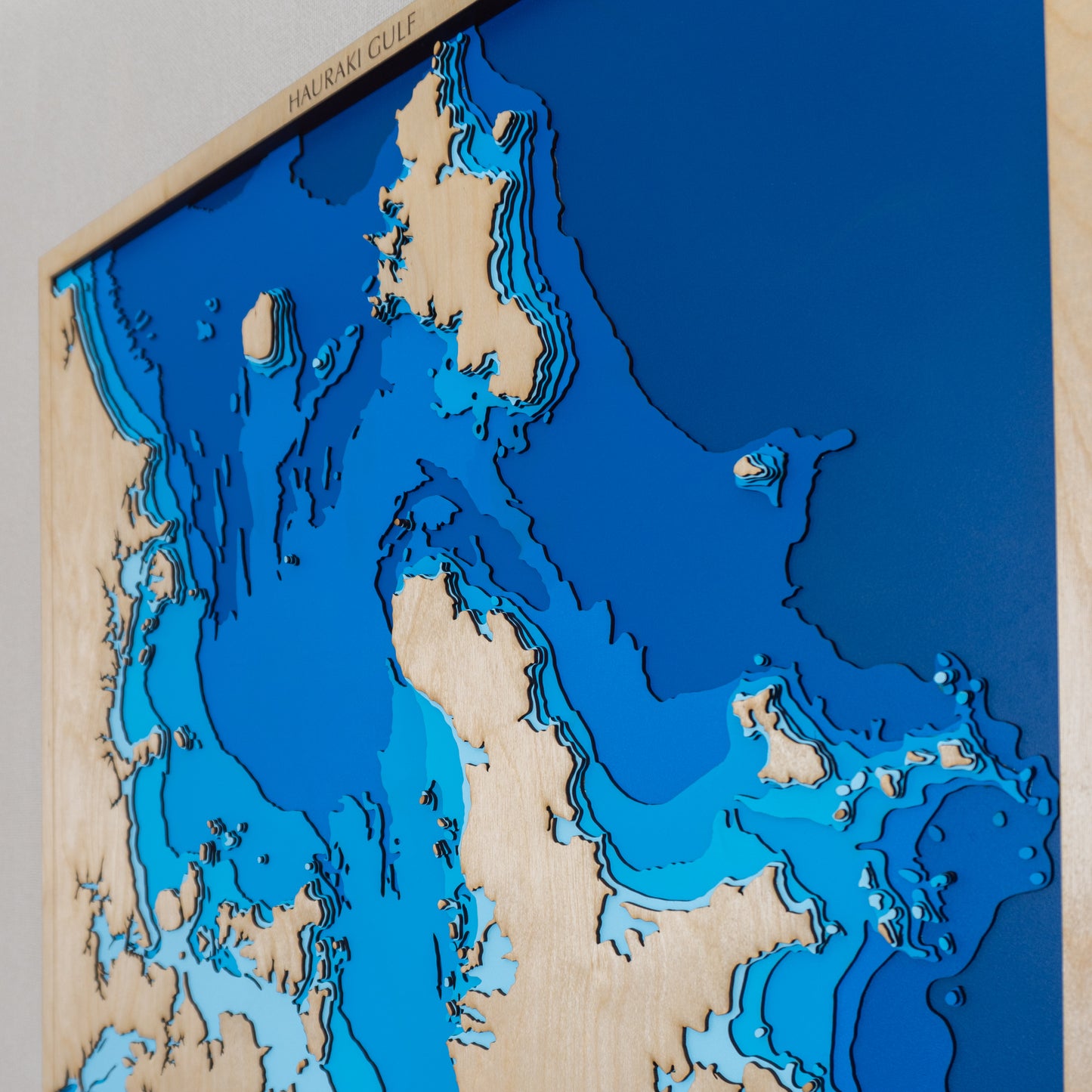 Close-up view of the Wider Hauraki Gulf II XL map showing detailed laser-cut bathymetric layers and coastal features.
