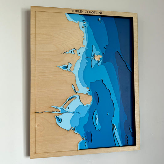 Handcrafted wooden depth map of Dublin, Ireland, showcasing laser-cut layers depicting the city's coastline, the River Liffey, and surrounding bathymetric contours.