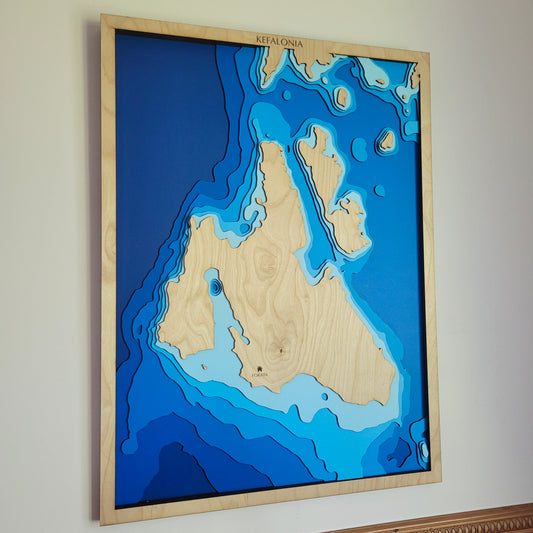Handcrafted wooden depth map of Kefalonia, Greece, showcasing laser-cut layers depicting the island's rugged mountains, pristine beaches, and surrounding Ionian Sea contours.