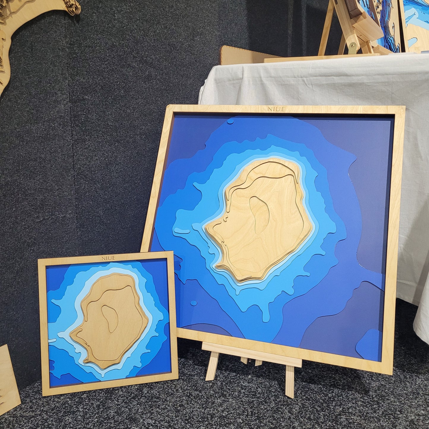 Laser-cut wooden depth map of Niue Island in Small size, highlighting the rugged coastline and ocean contours in layered Baltic birch plywood.