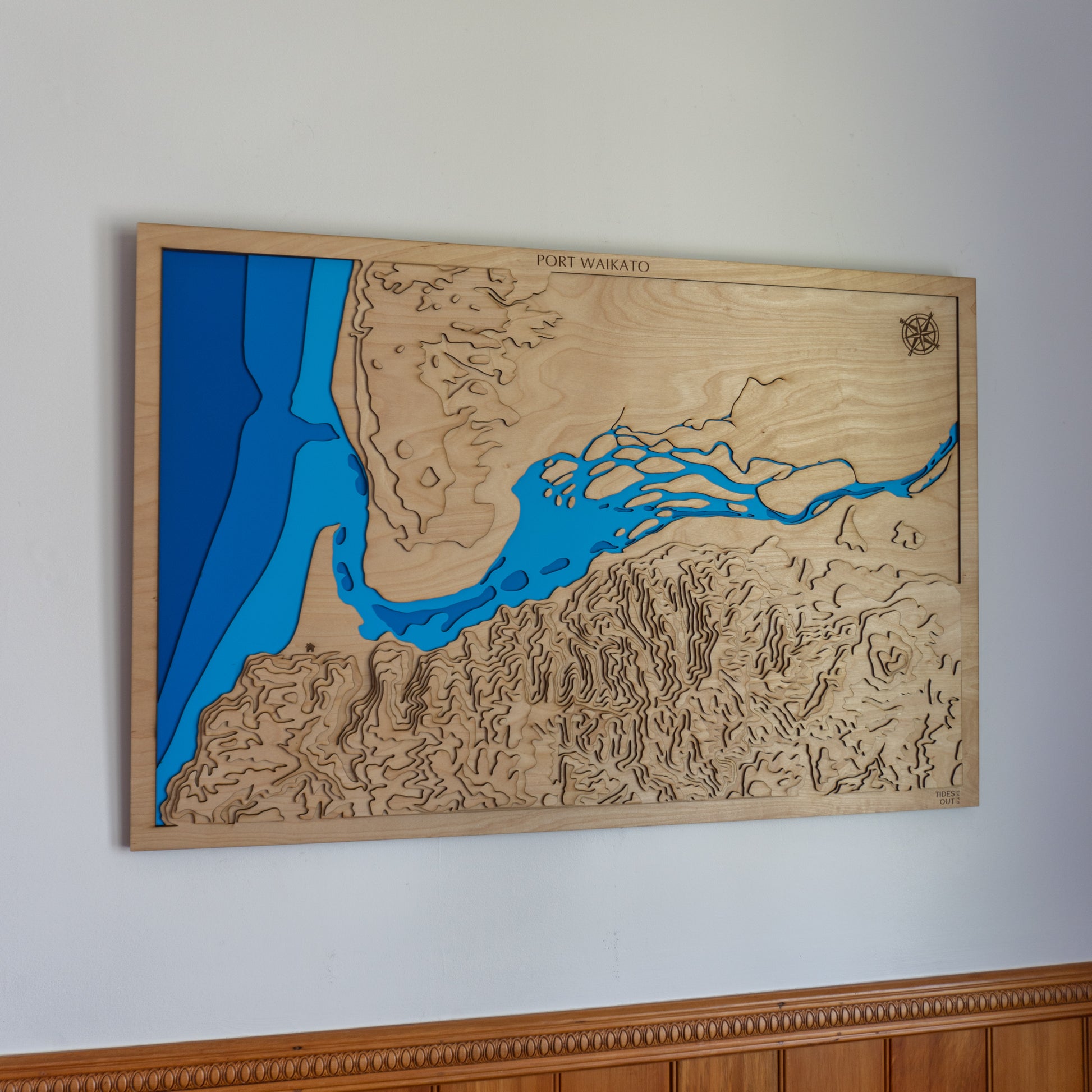 Port Handcrafted wooden depth map of Port Waikato, featuring laser-cut layers depicting the Waikato River mouth, rugged surf coastline, and black sand beaches.Waikato - Tide's Out Maps