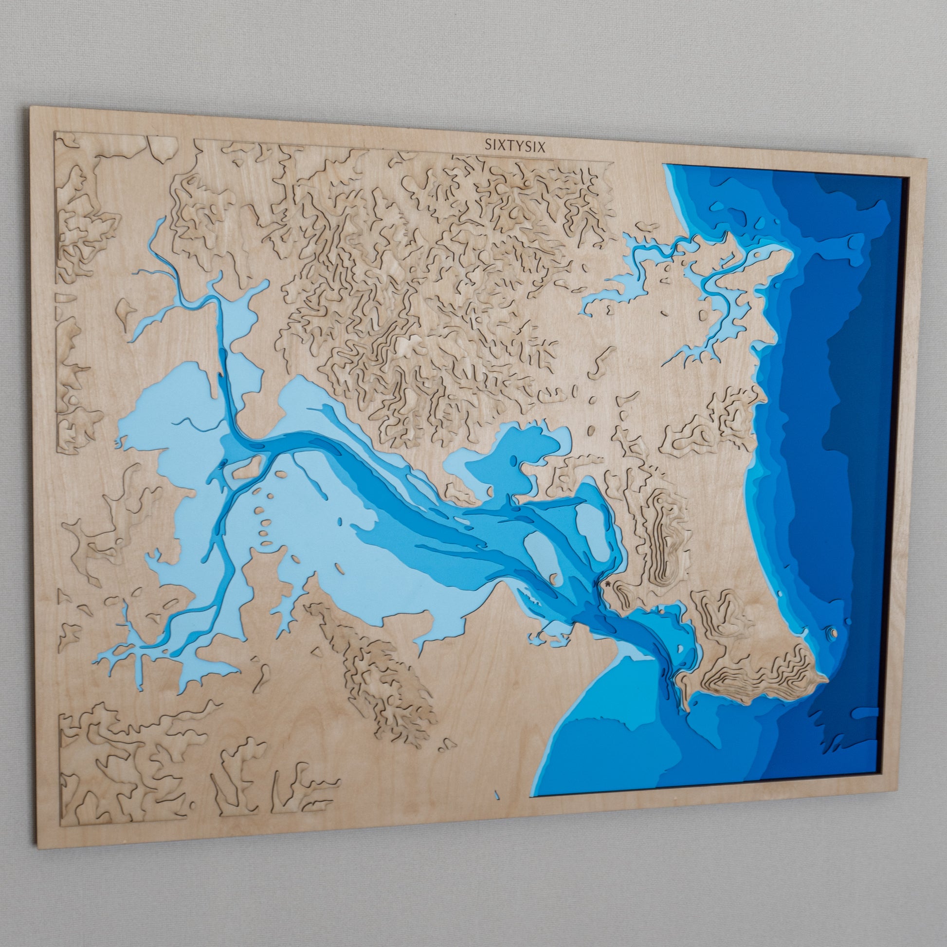 Side angle of the Whangarei Harbour wooden map, emphasizing the depth layers and natural wood grain.