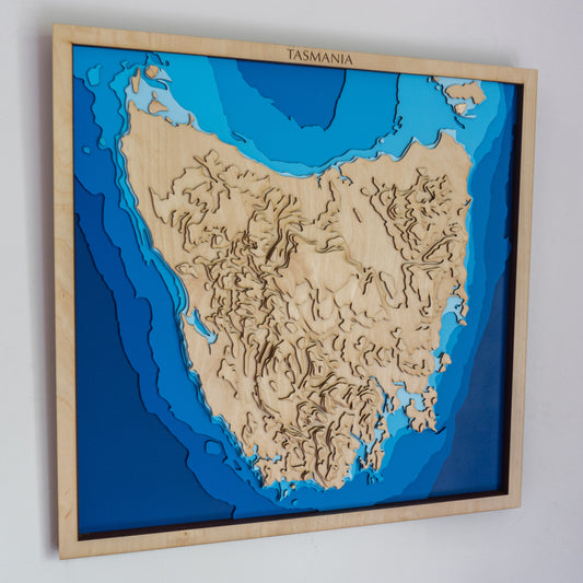 Handcrafted wooden depth map of Tasmania, showcasing laser-cut layers depicting the island's rugged coastlines, pristine beaches, and lush wilderness.