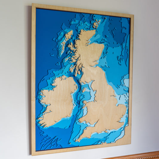 Handcrafted wooden depth map of the United Kingdom, featuring laser-cut European Birch layers illustrating sea depths from sea level to -500 meters, highlighting the UK's intricate coastlines and surrounding bathymetric contours.