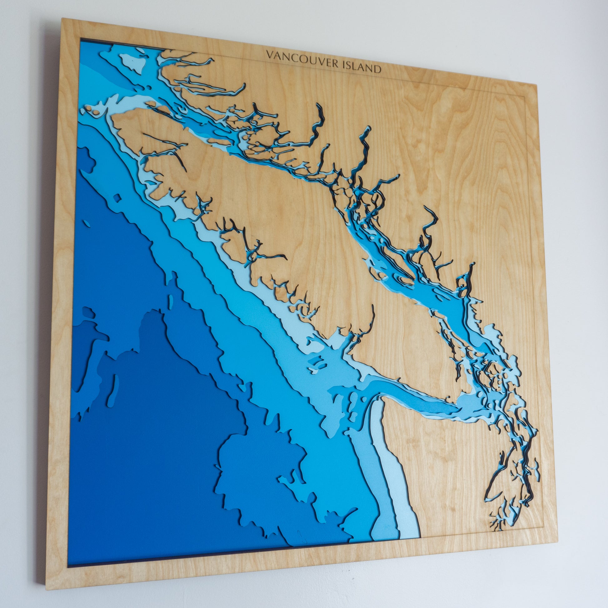 Handcrafted wooden depth map of Vancouver Island, British Columbia, Canada, featuring laser-cut European Birch layers illustrating sea depths from sea level to -4,000 meters, highlighting the island's rugged coastline and surrounding oceanic contours.