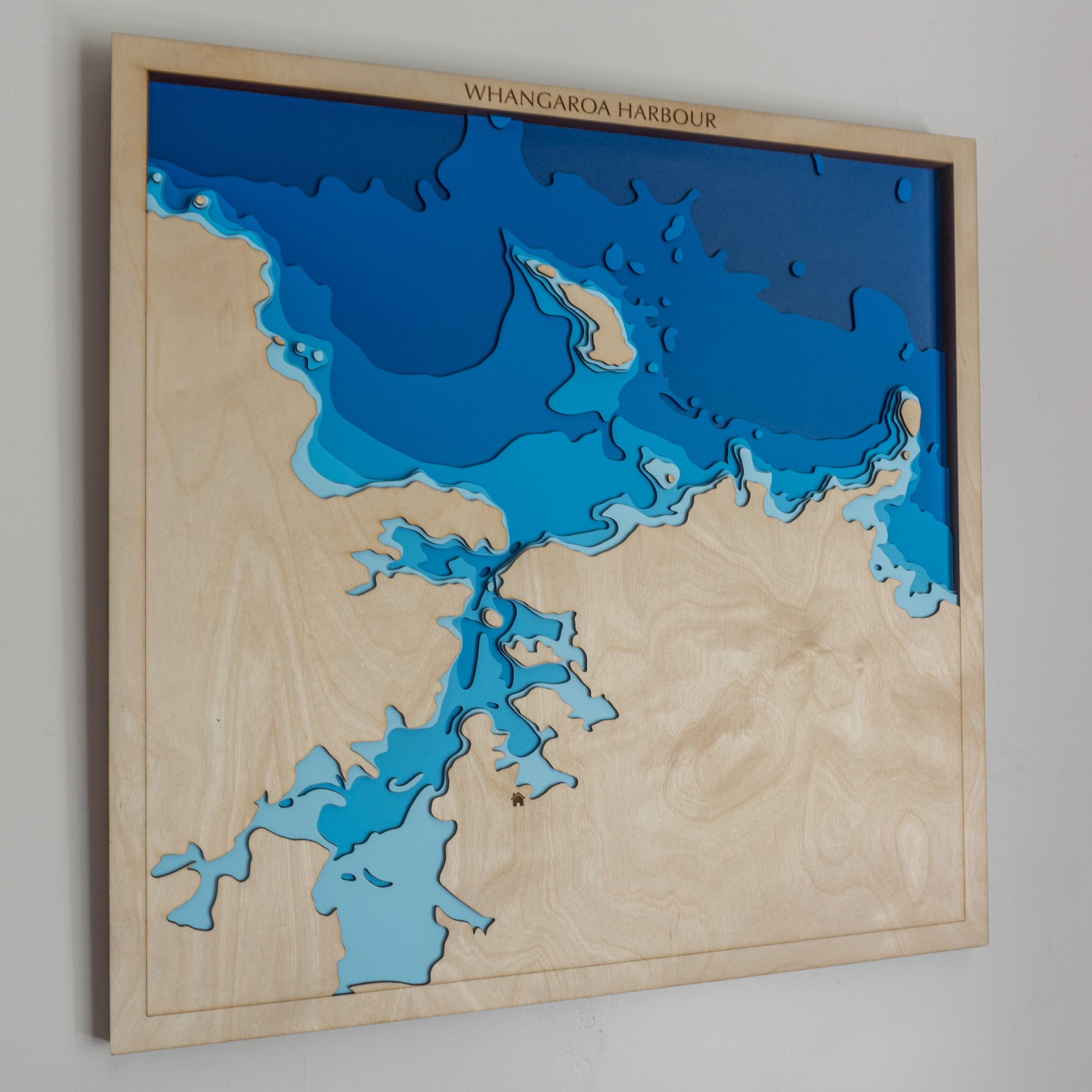 Handcrafted wooden depth map of Whangaroa Harbour II, showcasing laser-cut layers depicting the harbour's intricate coastline, serene coves, and surrounding lush hills.