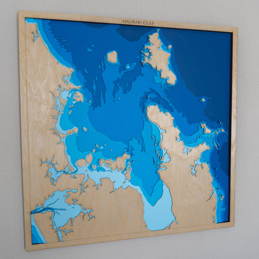 Extra-large handcrafted wooden depth map of the wider Hauraki Gulf, New Zealand, featuring laser-cut European Birch layers illustrating sea depths from sea level to -200 meters, highlighting the Hauraki Plains and Coromandel Peninsula.
